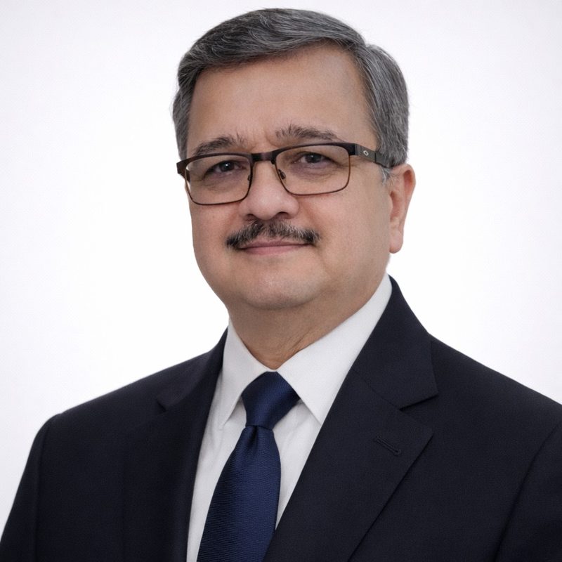 Portrait of Dr Pankaj N Maheshwari, urologist, in a dark suit and navy tie